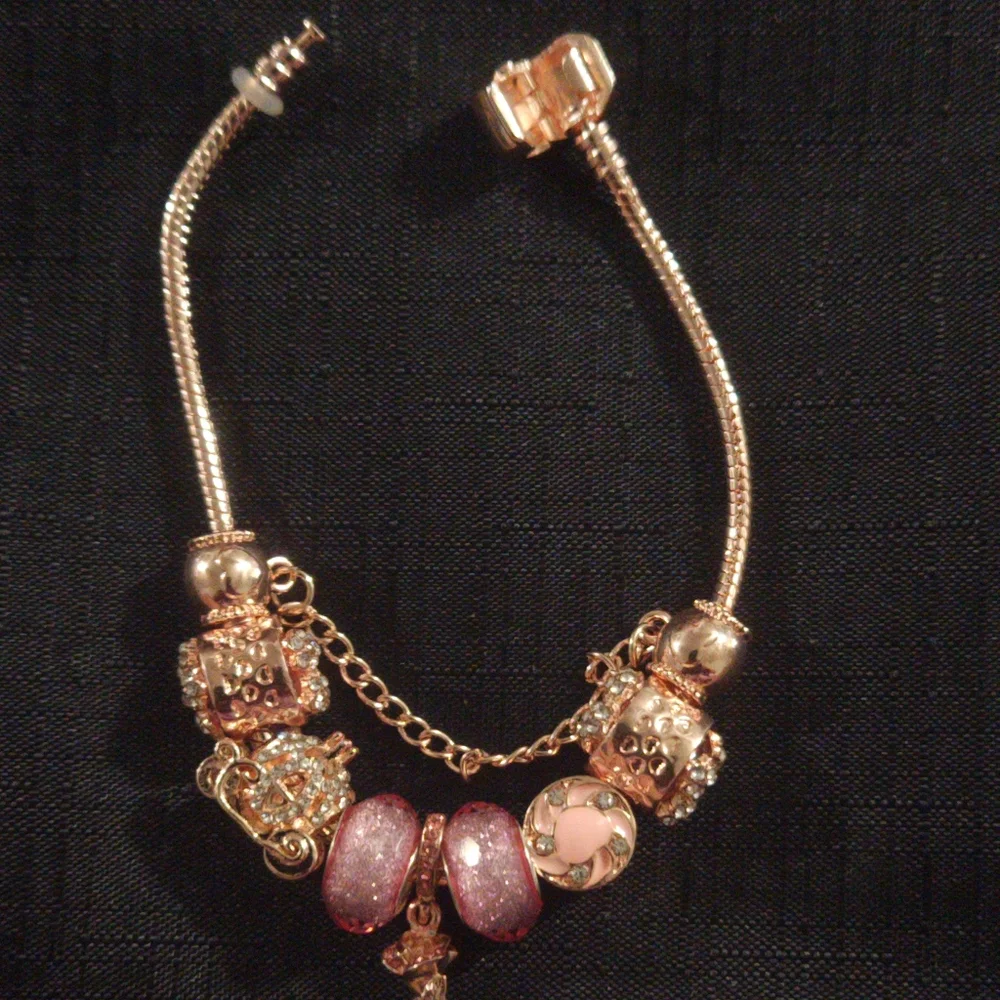 Gold and Pink Charm Bracelet with Ornate Charms. ITEM No. 19-144
